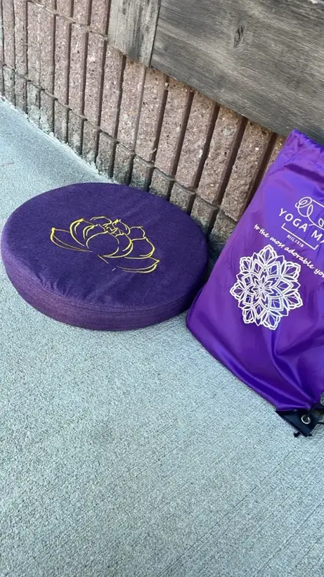 Dark purple StillSeat meditation cushion next to its delivery bag, photographed by a verified buyer